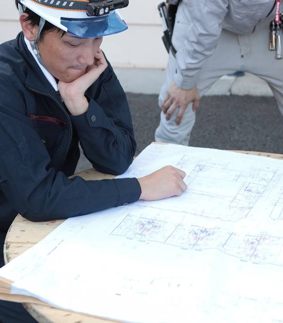 設計図を見ている作業員